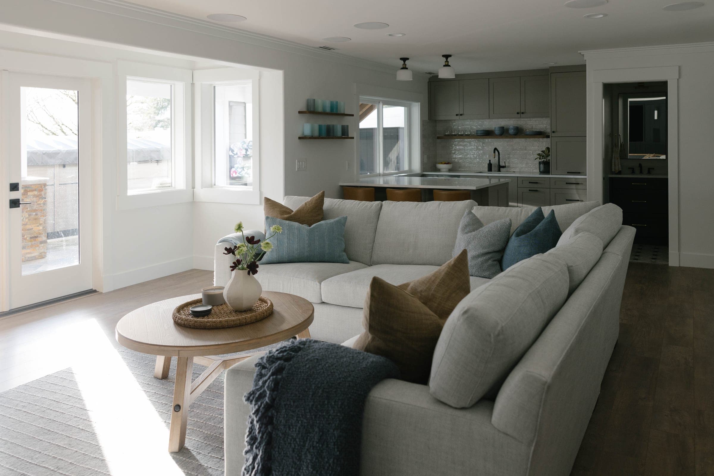 Bright wide view of the Highlands Basement in Issaquah, from the living room to the kitchen