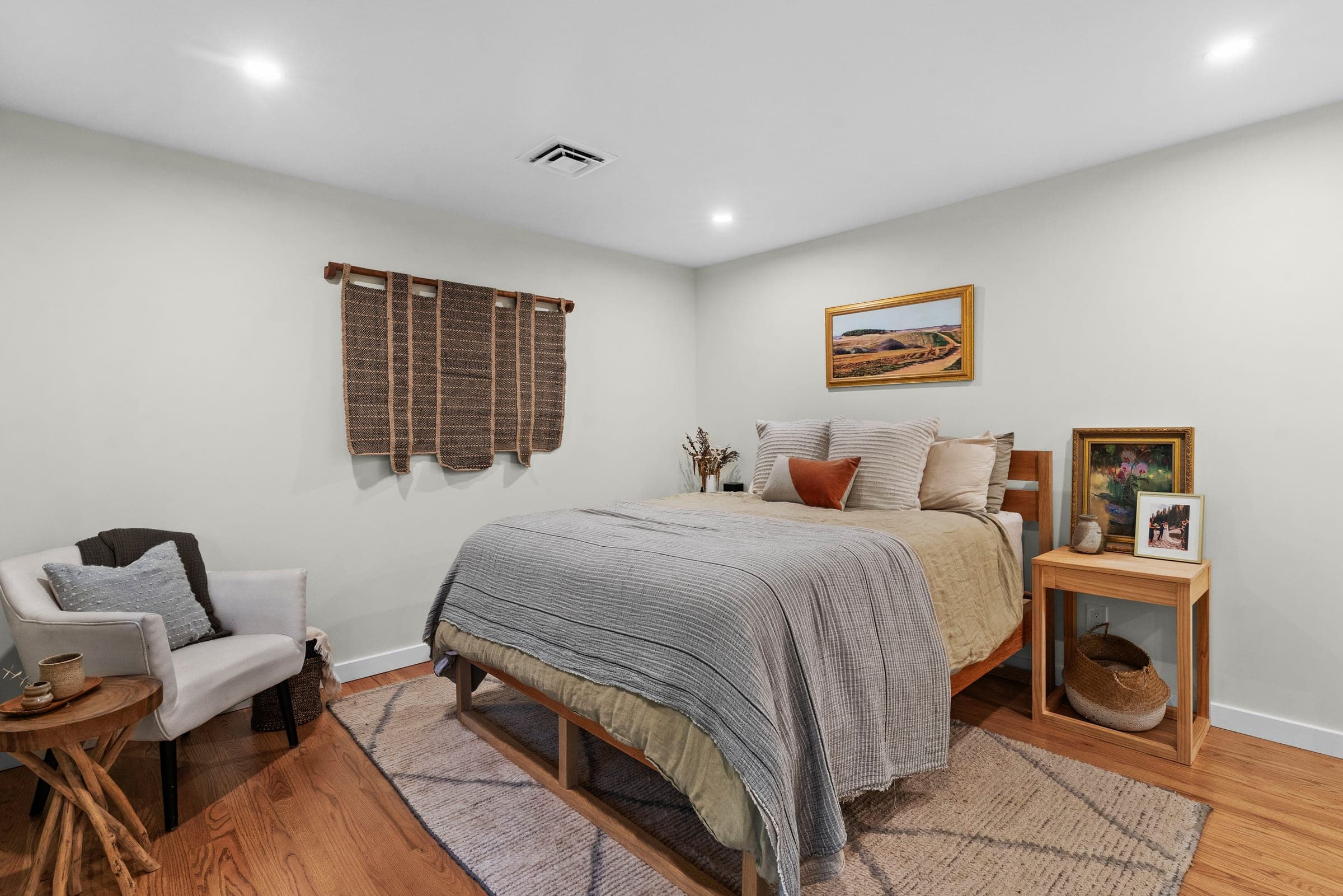 River Front Master Suite bedroom with refinished hardwood floors and a reading chair, North Bend