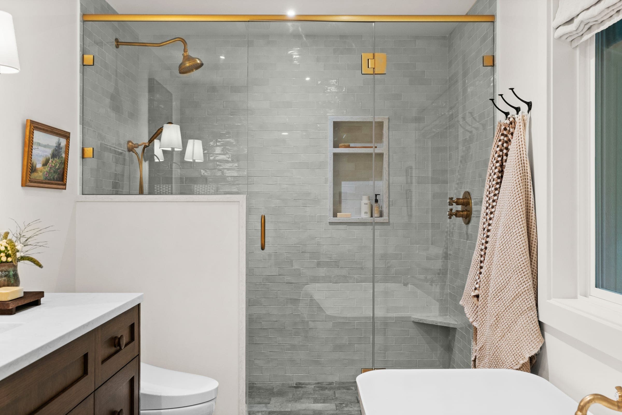 Fully tiled shower with unlacquered brass fixtures in the River Front Master Suite ensuite