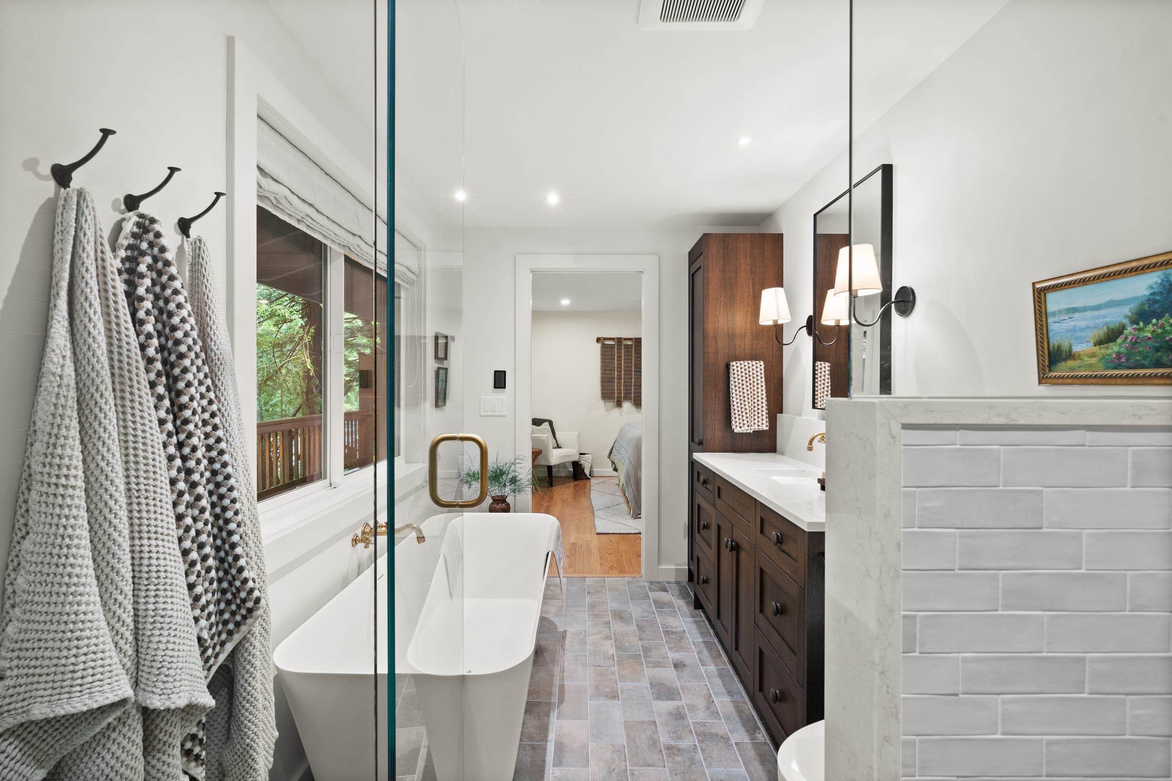 River Front Master Suite ensuite seen through the glass shower door, with the freestanding tub